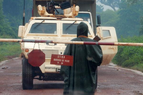 Central African soldier bars the road for a MINUSCA convoy